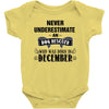 never underestimate an old man who was born in december Baby Onesie