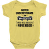never underestimate an old man who was born in november Baby Onesie