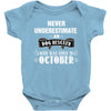 never underestimate an old man who was born in october Baby Onesie