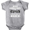 never underestimate an old man who was born in march Baby Onesie