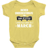 never underestimate an old man who was born in march Baby Onesie