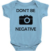 don't be negative camera Baby Onesie