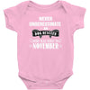 never underestimate an old man who was born in november Baby Onesie