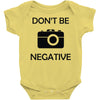 don't be negative camera Baby Onesie