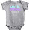 she is strong Baby Bodysuit
