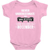 never underestimate an old man who was born in december Baby Onesie