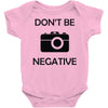 don't be negative camera Baby Onesie