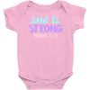 she is strong Baby Bodysuit
