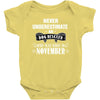 never underestimate an old man who was born in november Baby Onesie