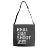 real men shoot raw Adjustable Strap Totes