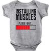 new installing muscle Baby Onesie