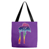 giraffe reaching up with its long neck to eat leaves off branches from Tote Bags