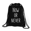 now or never Drawstring Bags