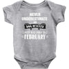 never underestimate an old man who was born in february Baby Onesie