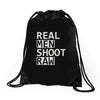 real men shoot raw Drawstring Bags