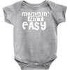 mommin' ain't easy Baby Onesie