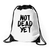 not dead yet Drawstring Bags