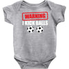 warning i kick balls Baby Onesie