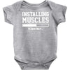 installing muscles funny Baby Onesie