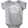 mustaching through snow Baby Onesie