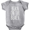 born on the beach Baby Onesie