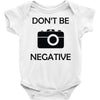 don't be negative camera Baby Onesie