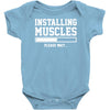 installing muscles funny Baby Onesie