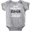 never underestimate an old man who was born in january Baby Onesie