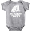 still plays with trucks Baby Onesie