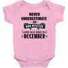 never underestimate an old man who was born in december Baby Onesie