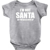 i'm not santa but sit on my lap Baby Onesie