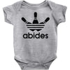 the dude abides Baby Onesie